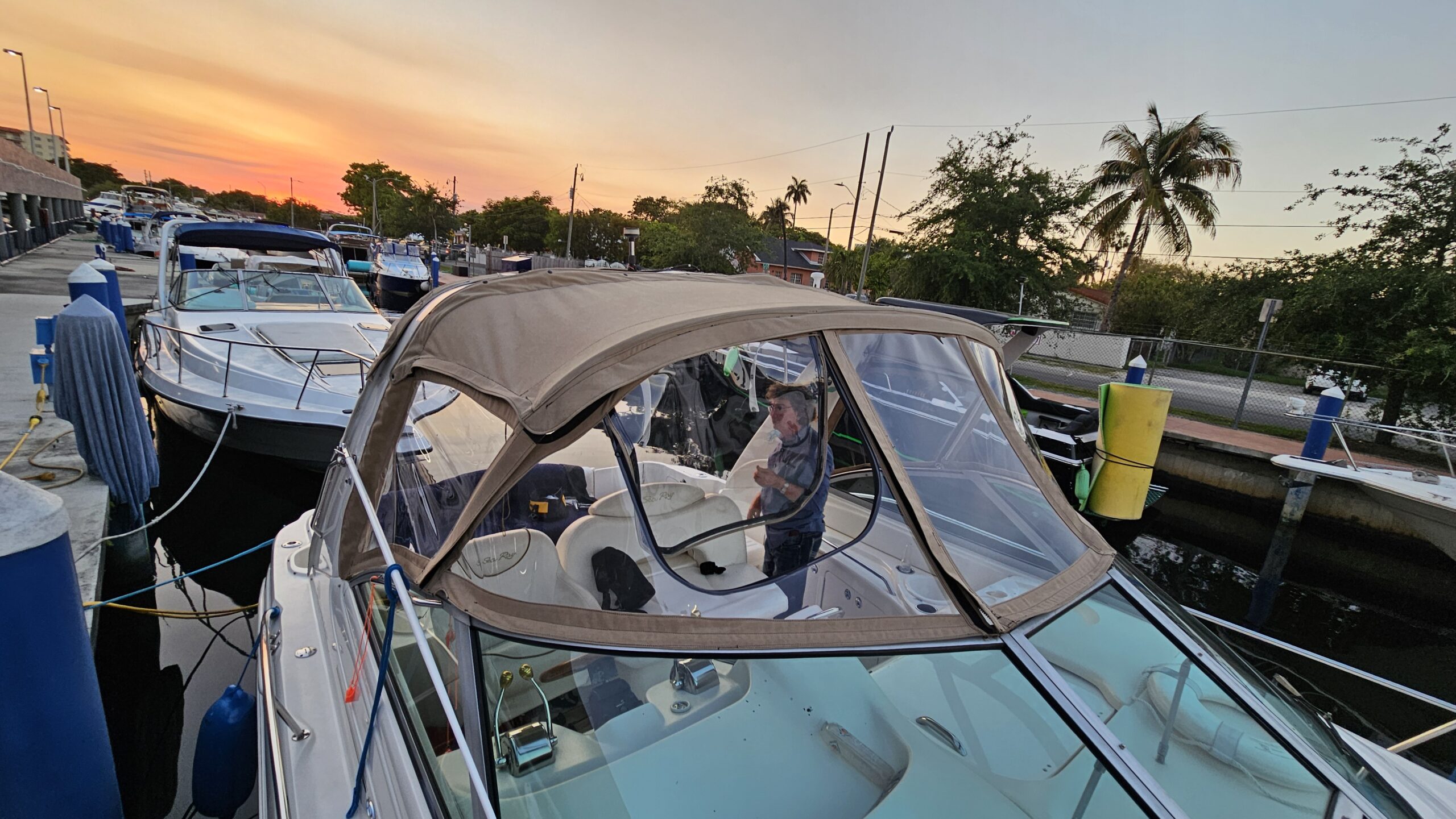 Boat with custom canvas enclosure at sunset